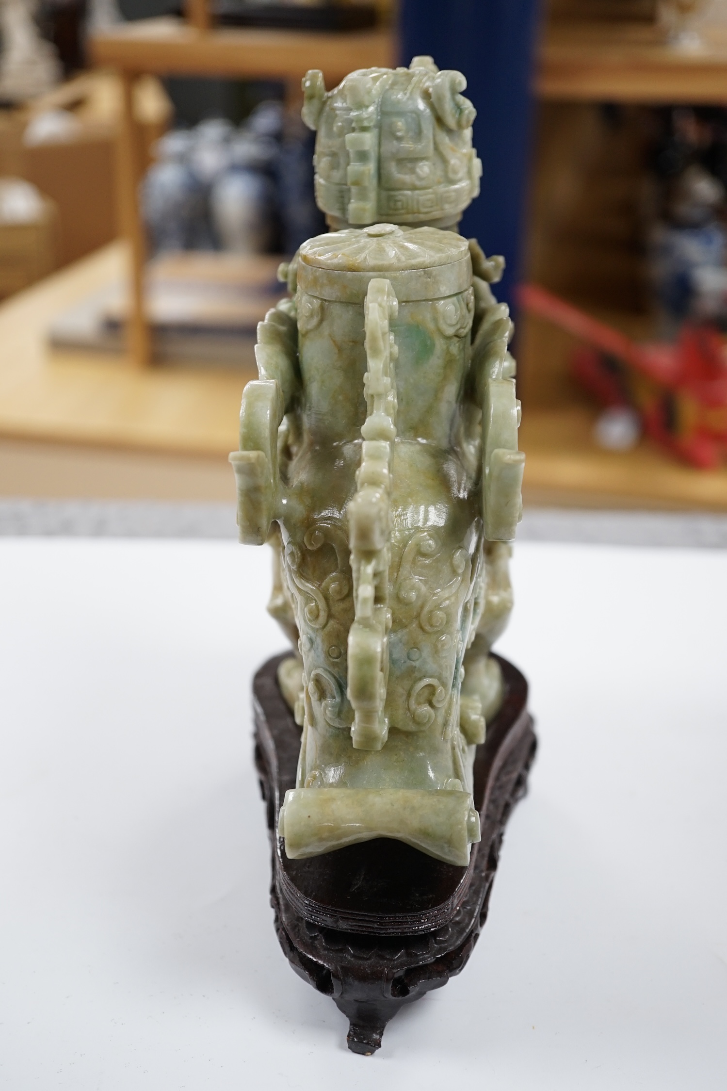 A large Chinese archaistic jadeite ‘phoenix’ vessel and cover, wood stand, 22cm high. Condition - fair